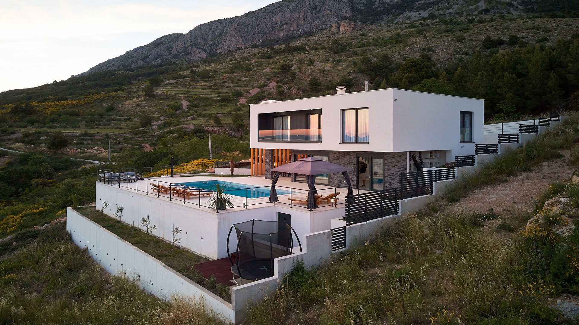 A modern villa with a pool and an amazing sea view