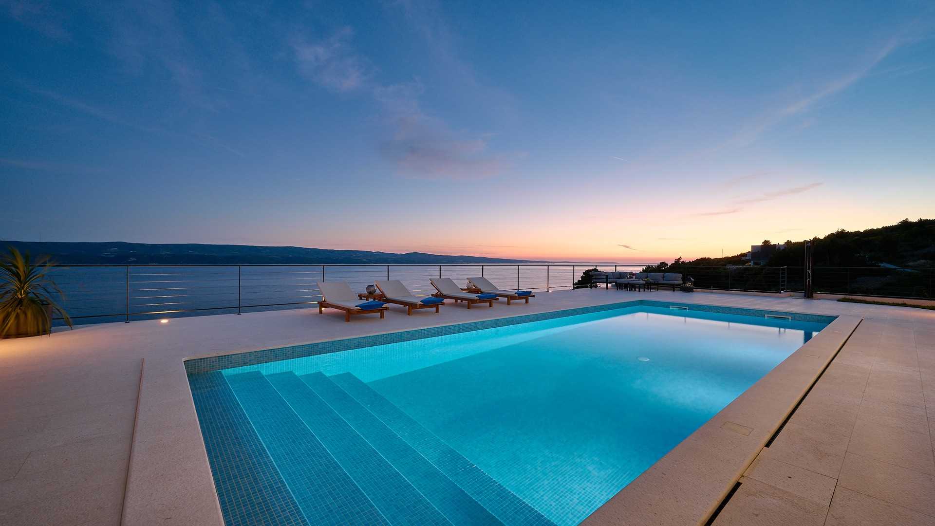 A modern villa with a pool and an amazing sea view